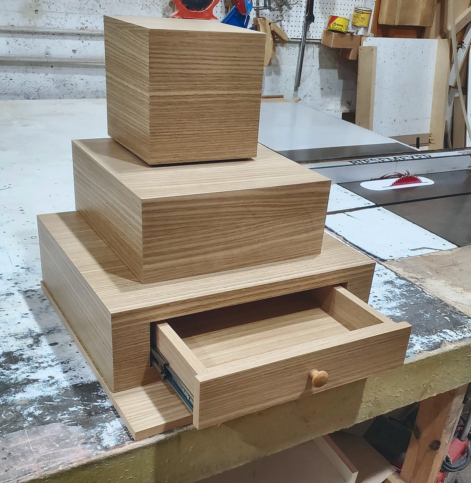 Oak pedestal with open drawer