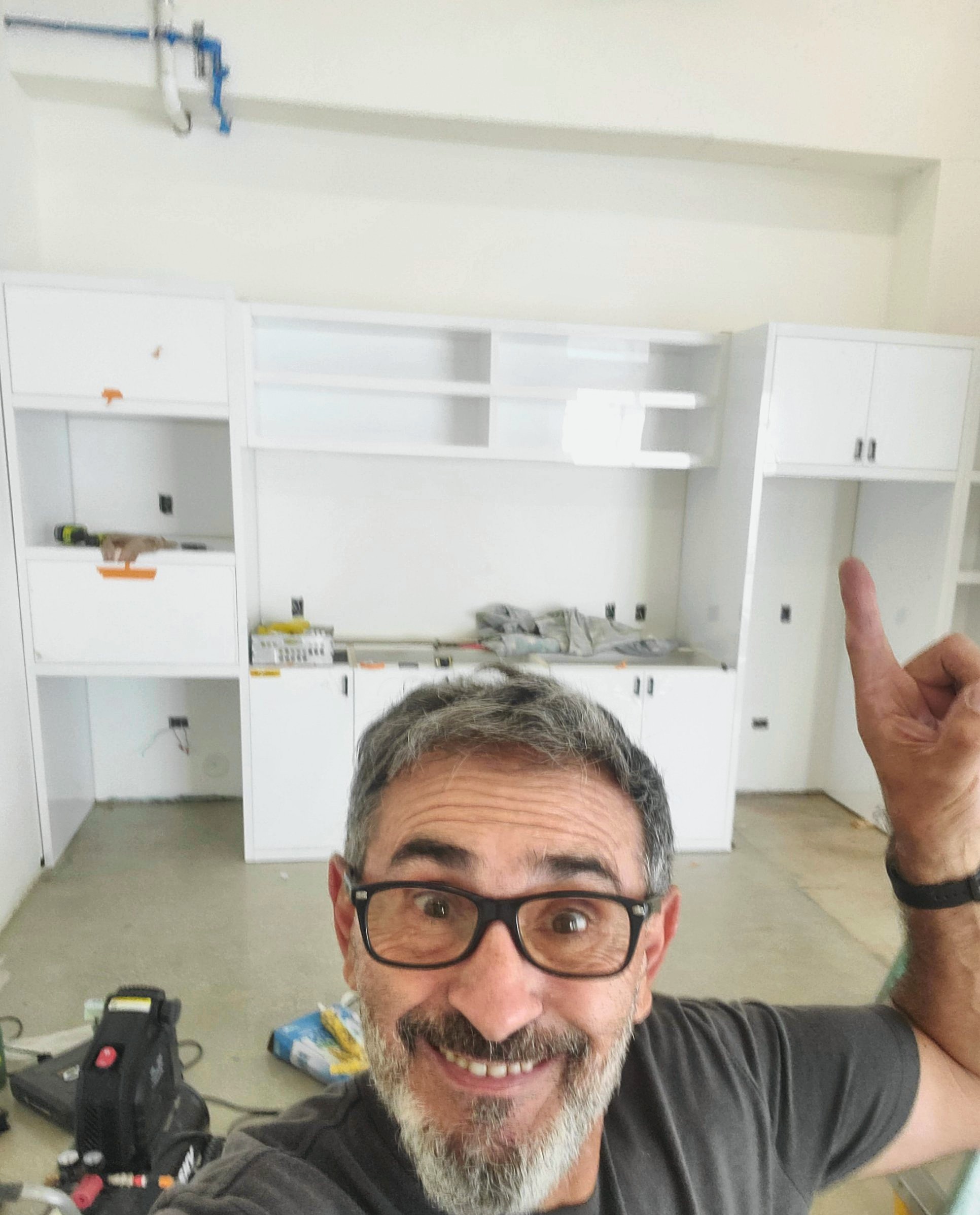 Gabriel Ganga on site in front of a kitchenette he built