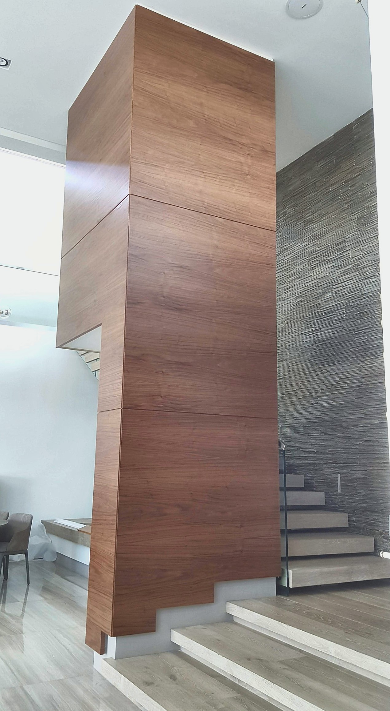 Walnut-clad double-height column